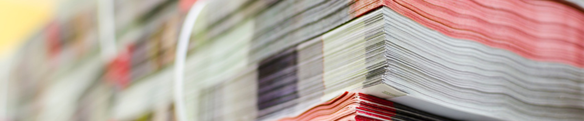 Pile of bundled magazines in offset print plant delivery department, selective focus background